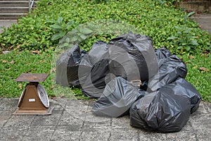 Scales and many of trash bag on the ground. Some of useless thing can change to money by selling its.