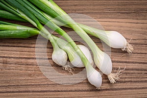 Scallions on a wooden board photo