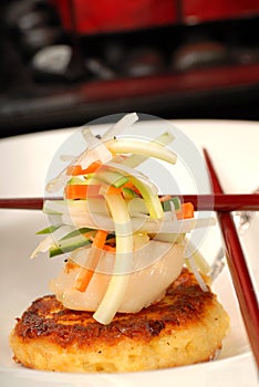 Scallop and crab cake appetizer with vegetables