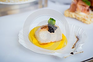 Scallop was served with yellow pumpkin cream sauce and on top with black caviar which put on shell