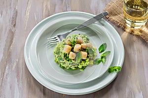 Scallops on minted pea risotto