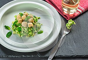 Scallops on minted pea risotto