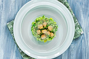 Scallops on minted pea risotto