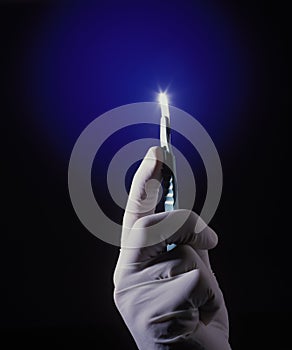 A scalpel in a surgeon's hand