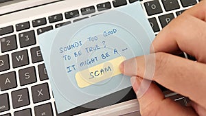 Scam alert concept. Finger pointing a note with the words Sounds Too Good To Be True It Might Be A Scam