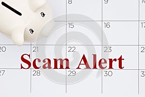 Scam Alert message with piggy bank on a calendar