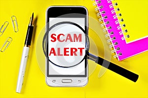 Scam alert-a message on the smartphone screen. Fraud is theft or acquisition of the right to another`s property by deception or