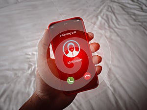 Scam call alert with red scammer icon as unknown caller, malicious phone calls concept. Unknown number Incoming displayed showing photo
