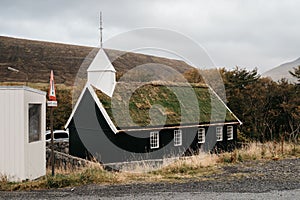 Scandinavian church surrounded by mountains. Hvalvikar kirkja, Faroe Islands