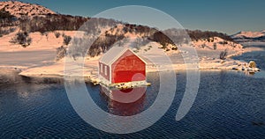 Scandinavian cottage house In a nordic sea, Rorbu fishing villa in a water, Lofoten Islands seascape, Norway