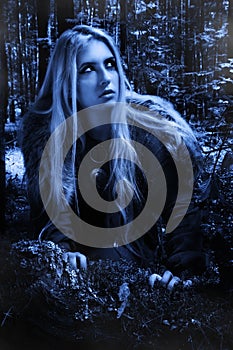 Scandinavian girl in the night forest