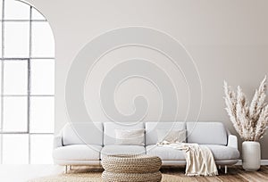 Scandinavian living room design with rattan table, pampas and white sofa on beige background