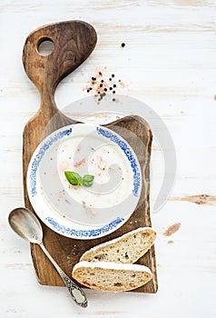 Scandinavian salmon soup with cream, fresh basil