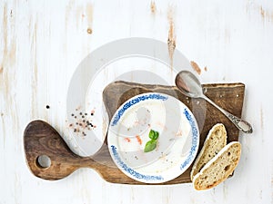 Scandinavian salmon soup with cream, fresh basil