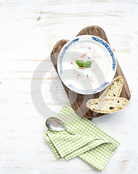 Scandinavian salmon soup with cream, fresh basil