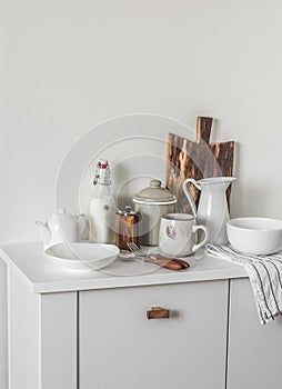 Scandinavian style kitchen interior. Dishes on a white cabinet. Cooking. Cozy kitchen