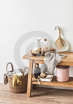 Scandinavian style laundry room interior - laundry basket, brushes, rons, cleaning and laundry products