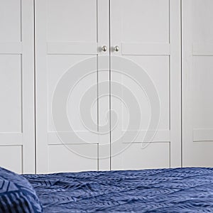 Scandinavian style. White bedroom with bright Scandinavian bedding
