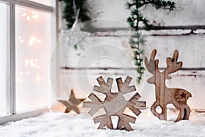 Scandinavian styled christmas card with wooden decoration beside a frosted window