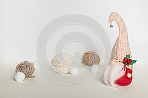 Scandinavian swedish gnome in red clothes and a hat with a bell with wool balls on a white background