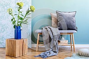 Scandinavian wooden bench with pillows and plaid.