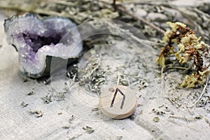 Scandinavian wooden runes futhark on a rough gray linen cloth