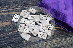 Scandinavian wooden runes on an old wooden table. Elder Futhark