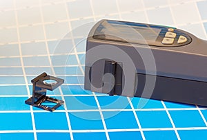 Scanning densitometer and a magnifyer on a leaf of the test print photo