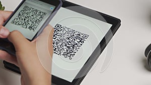 Scanning a QR code And Contactless Payments during Covid-19 Pandemic. A man scans the QR code displayed by the merchant