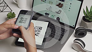 Scanning a QR code And Contactless Payments during Covid-19 Pandemic. A man scans the QR code displayed on the tablet to