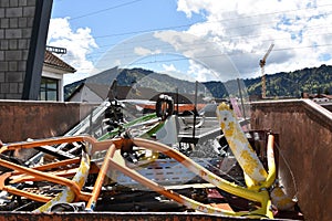 Scap iron in a big metal container in scrap collecting yard.