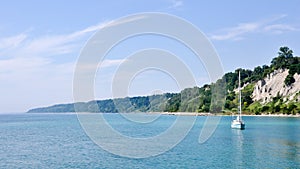 Scarborough Bluffs with boat on Lake Ontario on a sunny day - Toronto