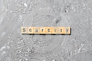 Scarcity word written on wood block. scarcity text on cement table for your desing, concept