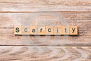 Scarcity word written on wood block. scarcity text on wooden table for your desing, concept