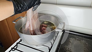 Scare and octopus cook boiling technique. Close shot of boiling an octopus in a pot.