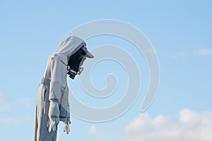 Scarecrow with gas mask against blue sky photo