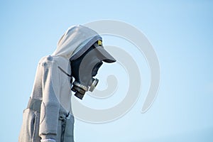 Scarecrow with gas mask against blue sky photo