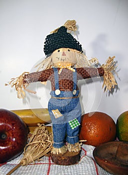 Scarecrow whih fruits and white background photo