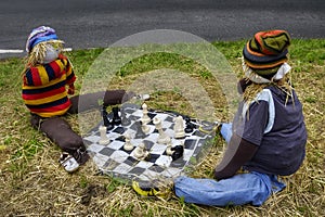 Scarecrows playing chess photo