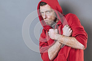 Scared 40s man standing with fists crossed on chest