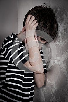 Scared and abused young boy photo