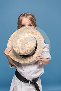 scared adorable little girl with straw boater