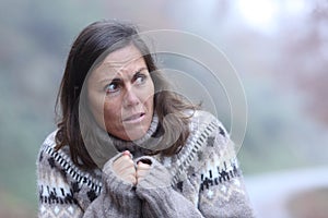Scared adult woman looking at side in a park