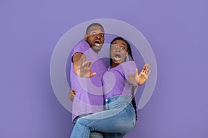 Scared African American couple screaming and gesturing stop