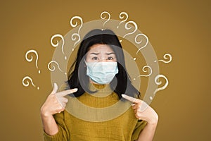 Scared Asian woman wearing protective mask on fear face hand pointing herself  with question mark worried about getting sick from