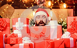 scared bearded man. winter shopping sales. Cheerful elf. christmas gift delivery. Boxing day. hipster santa hat