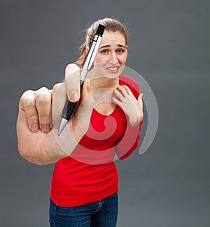 Scared beautiful young woman hesitating to sign a contract