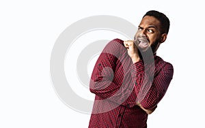 Scared Black Man Looking Aside In Fright Over White Background