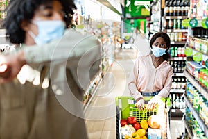 Scared Black Woman Looking At Sick Guy Coughing In Supermarket