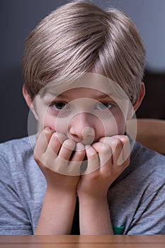 Scared boy biting nails